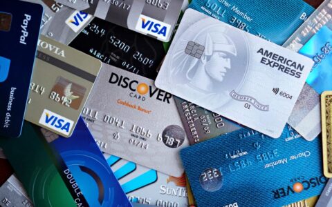 Close-up image of various credit cards including Visa, Mastercard, and American Express.